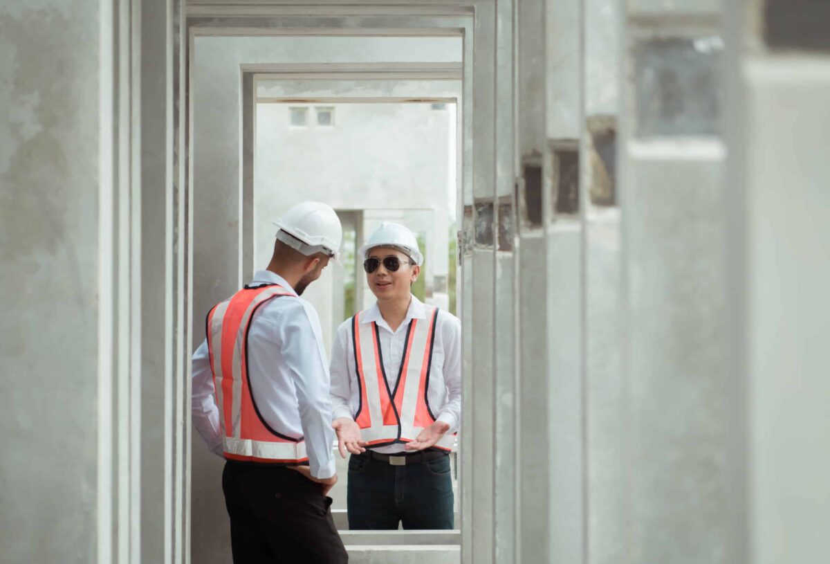Both of construction engineers verify the constructed precast concrete wall slabs' quality. also to oversee significant construction projects in the construction zone