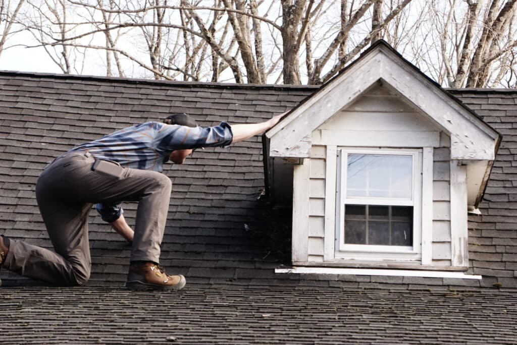 Inspector checking the rood on one knee